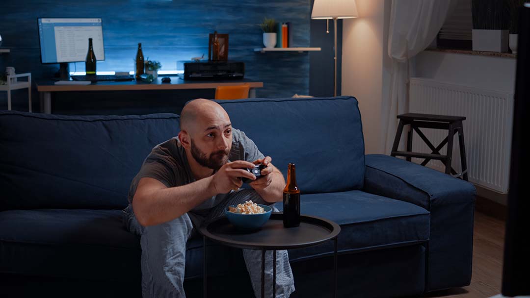 divorced man sitting alone in living room evening